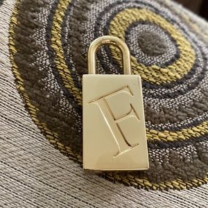 FURLA GOLD LOGO LOCK.